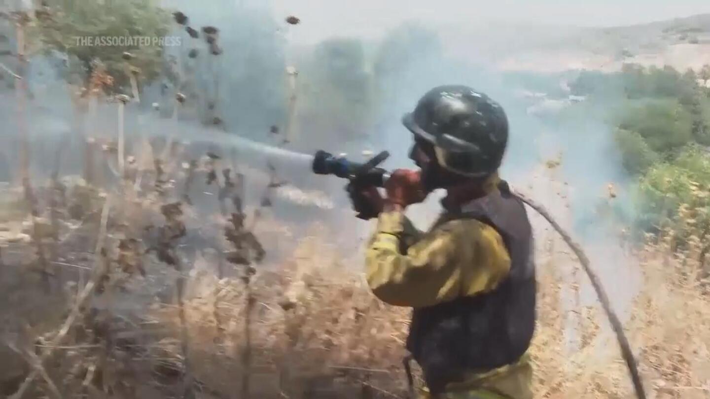 Strikes between Hezbollah and Israel spark fires on both sides of the frontline | AP News