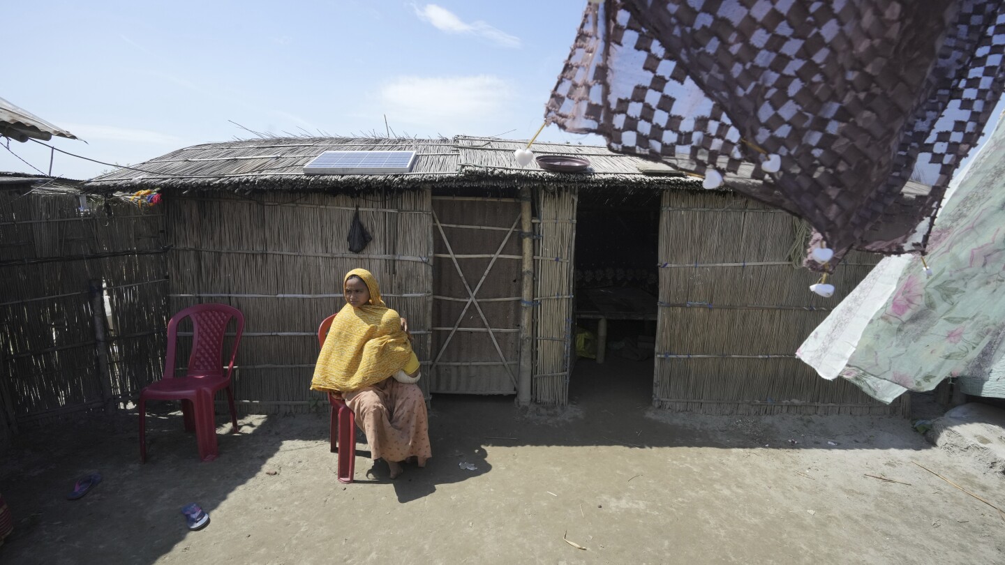 Indian mother delivers baby on boat as her river island is inundated by floodwaters