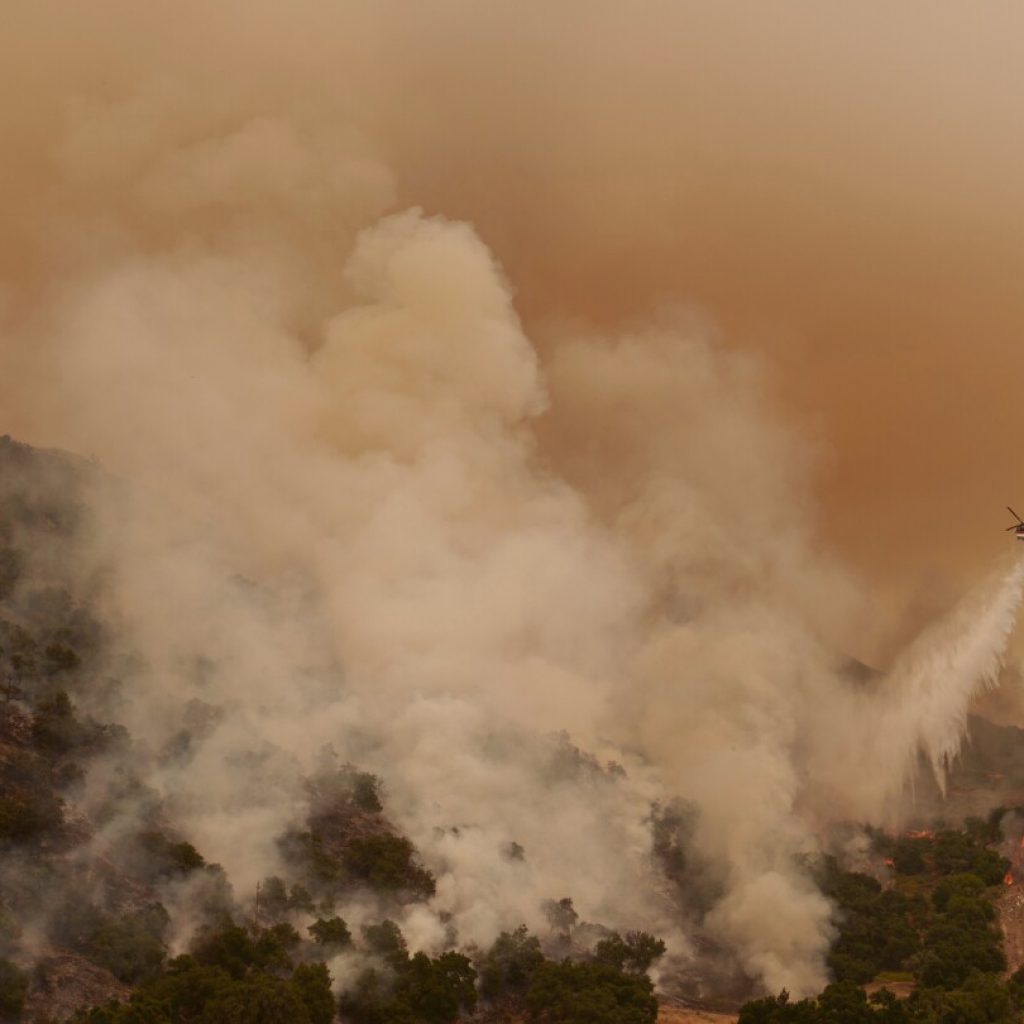 Torrid heat bakes millions of people in large swaths of US, setting records and fanning wildfires