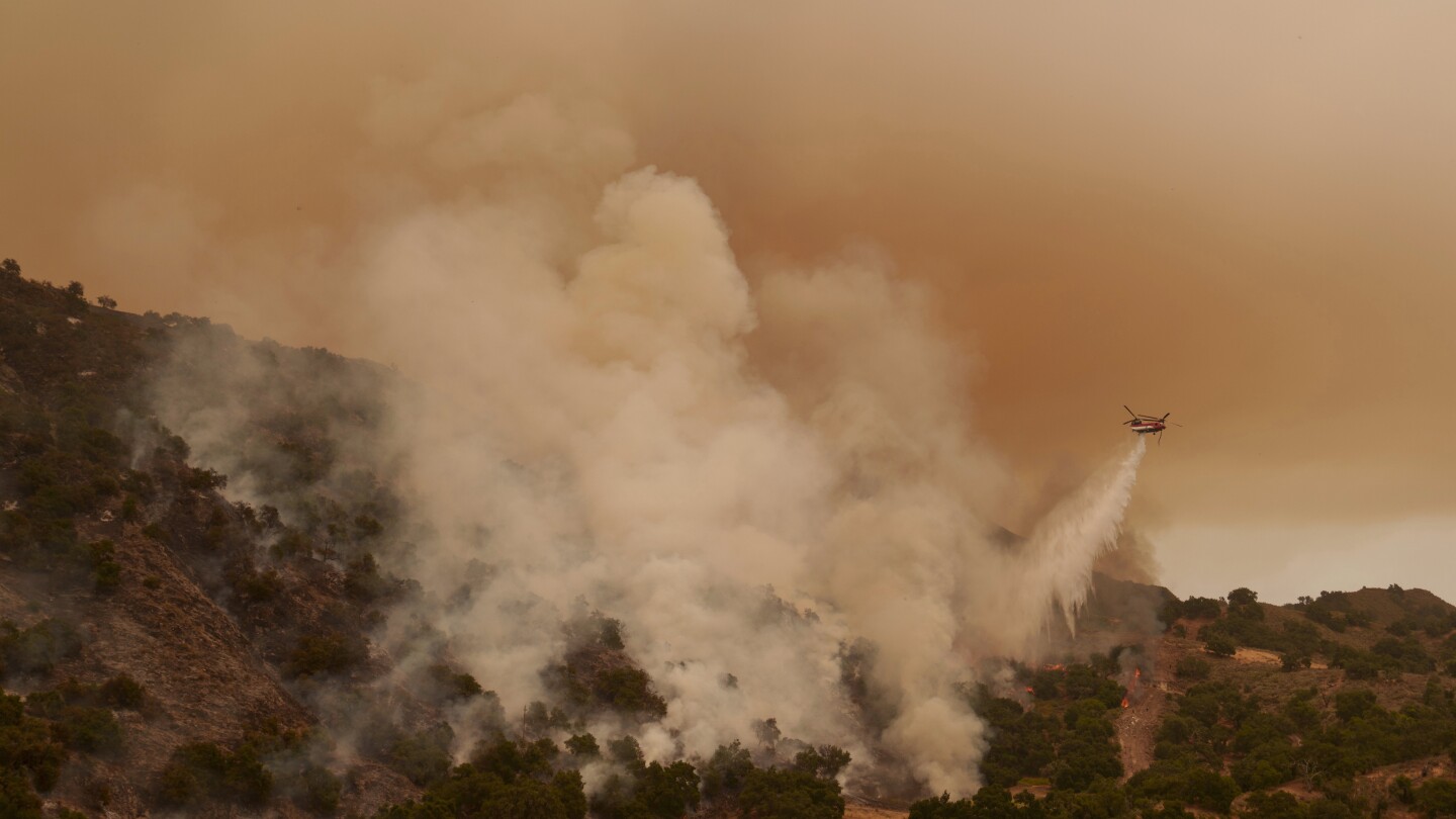 Torrid heat bakes millions of people in large swaths of US, setting records and fanning wildfires