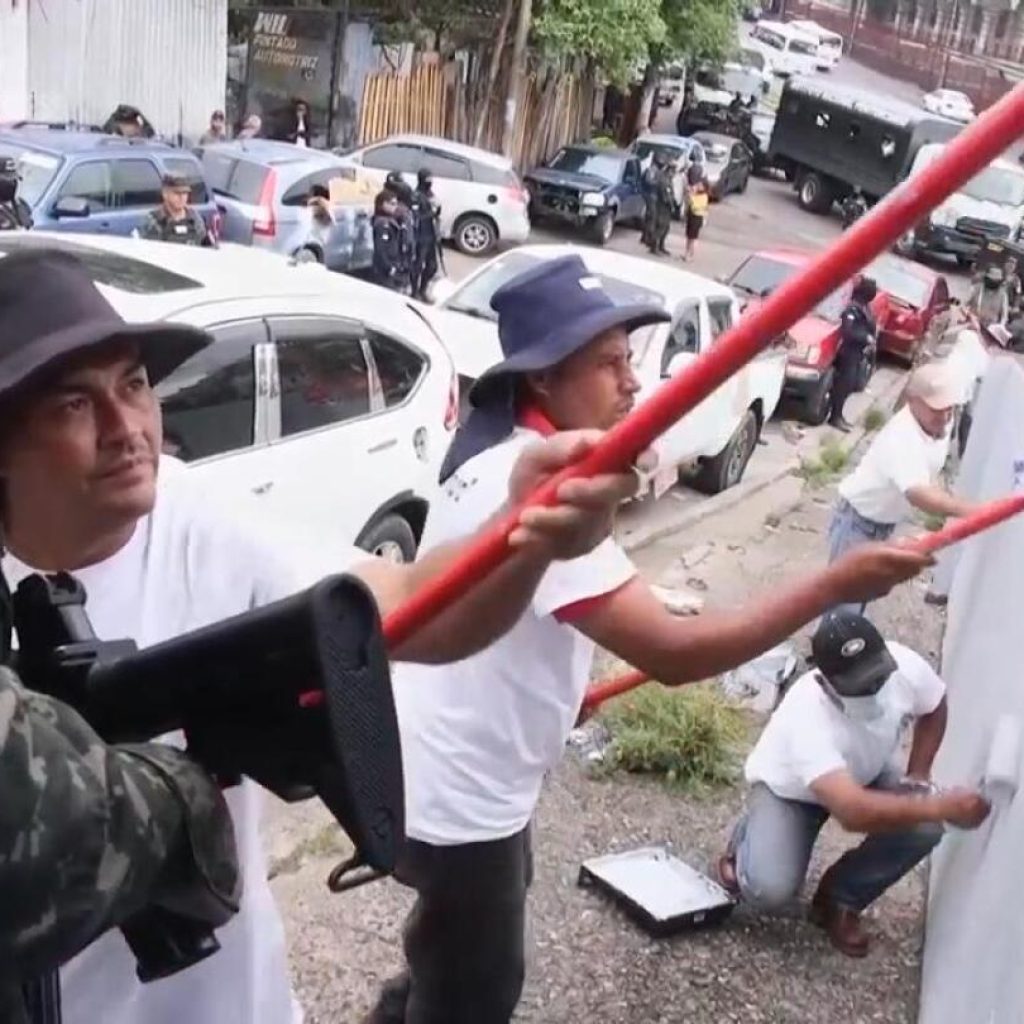 Honduras fights gangs by making jailed members paint over their graffiti | AP News