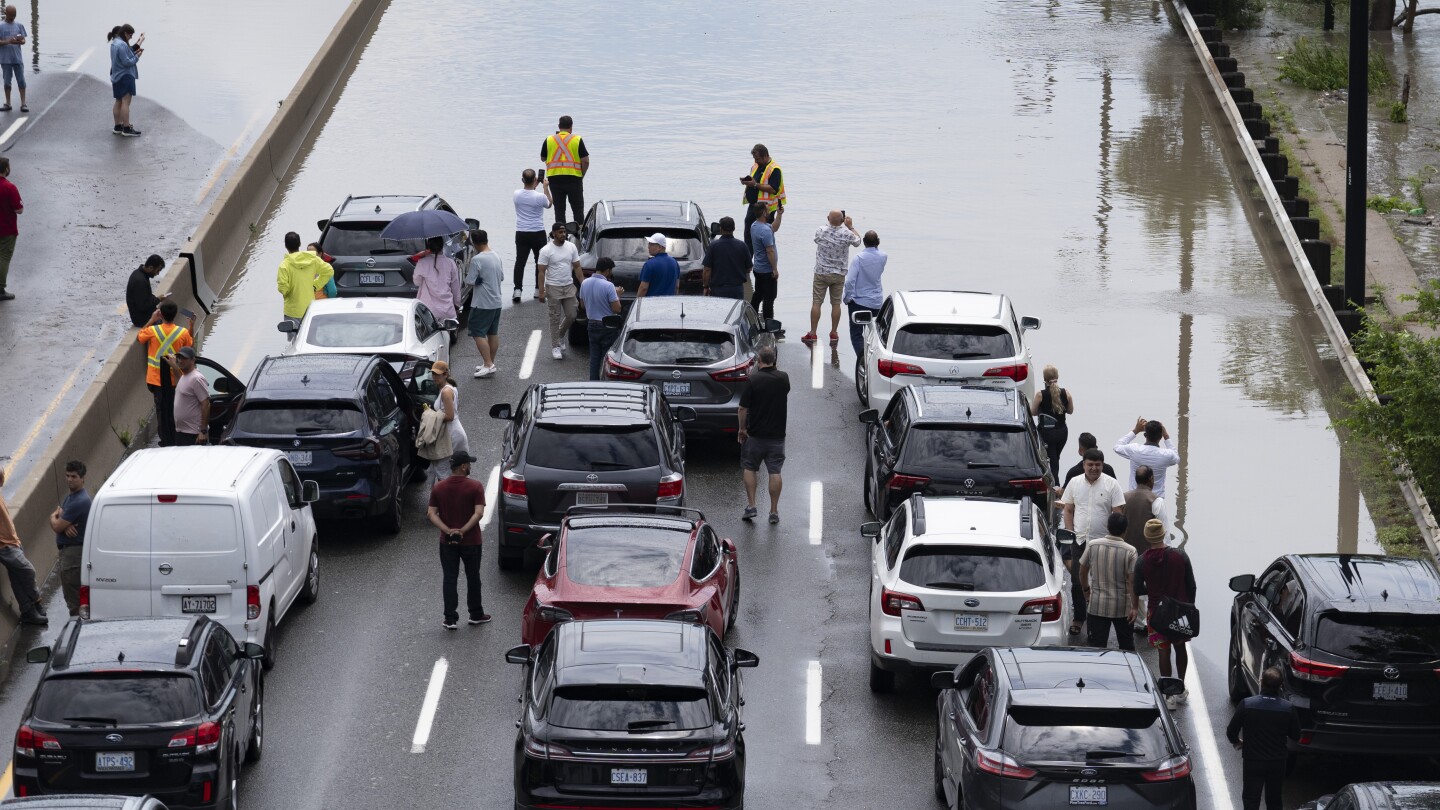 A major highway and roads are flooded as torrential rains hit Canada’s largest city