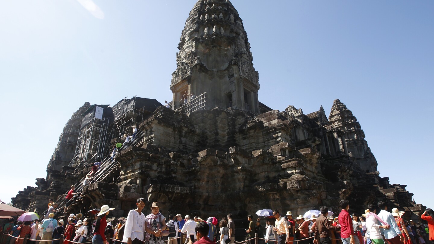 Fierce storm topples tree at Cambodian Angkor temple complex, killing 1 and damaging statues