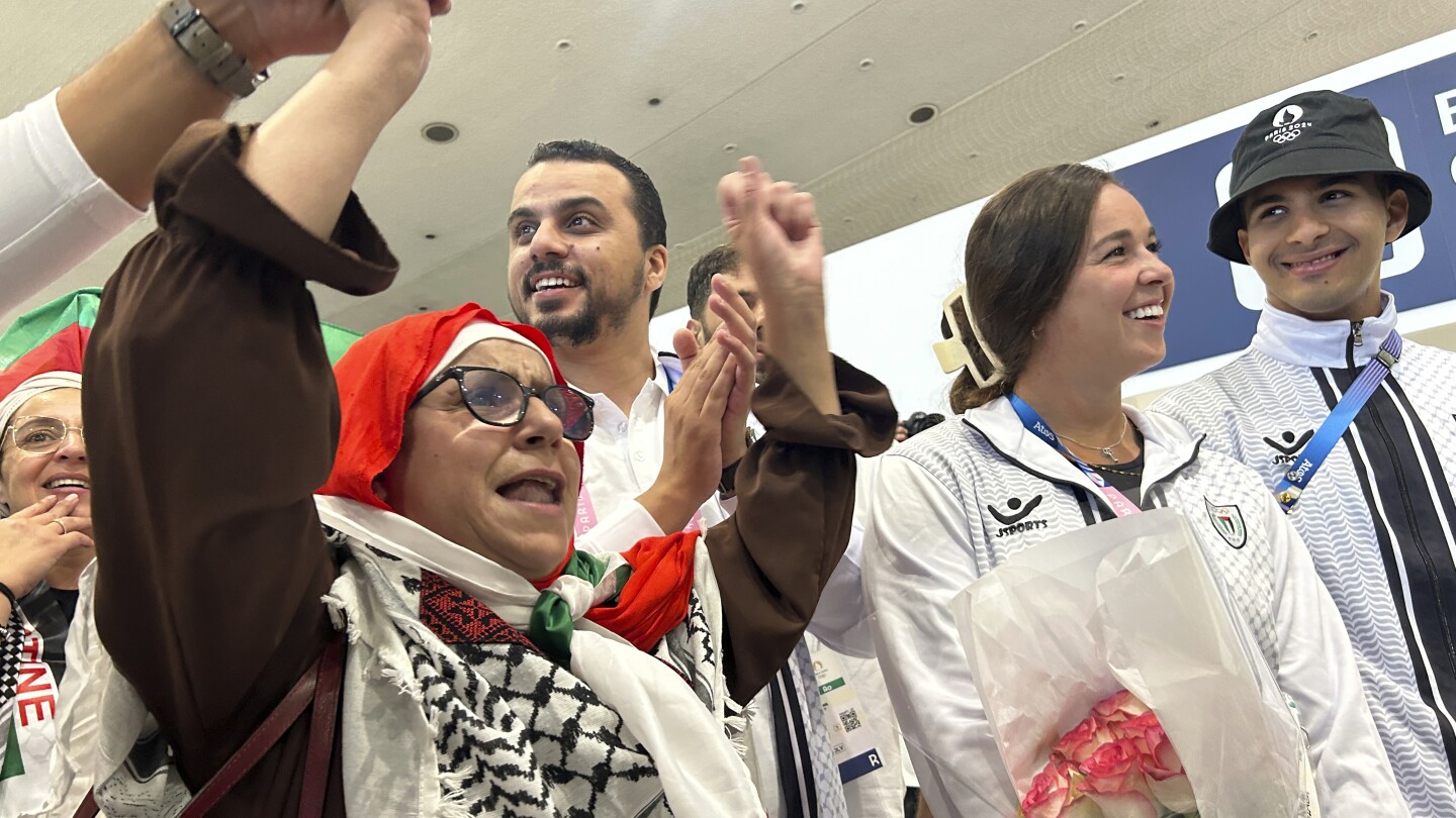 Palestinian Olympic team greeted with cheers and gifts in Paris