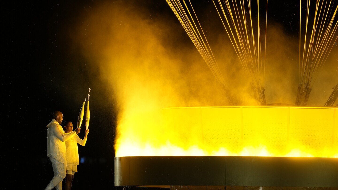 Olympic cauldron is lit by French gold medalists Teddy Riner and Marie-José Pérec