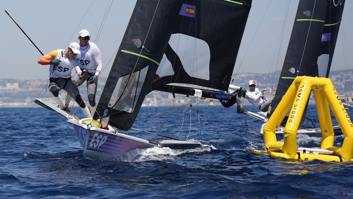 Olympic sailing ready to start with fast windsurfing, bird-like skiffs under light winds, hot sun