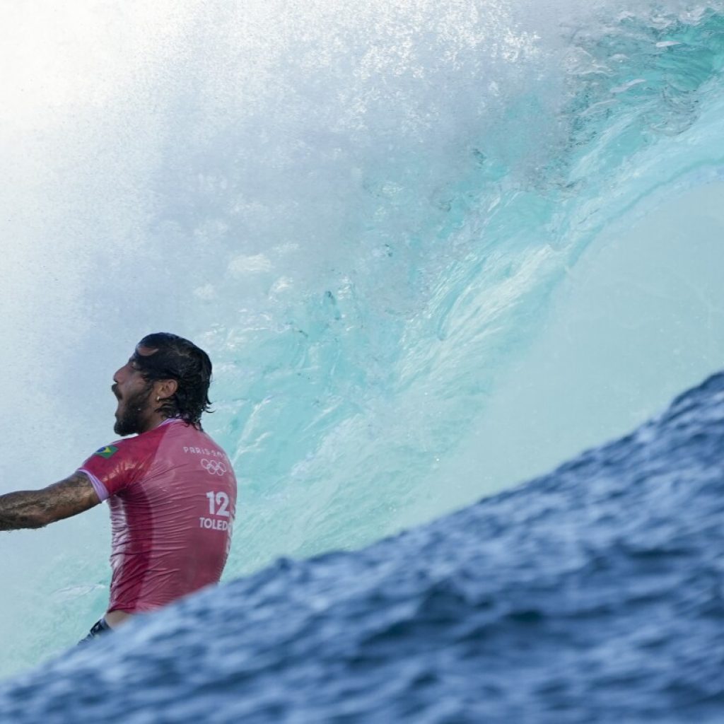 Jubilation and disappointment seen on shore as Paris Olympics surfing eliminations begin in Tahiti