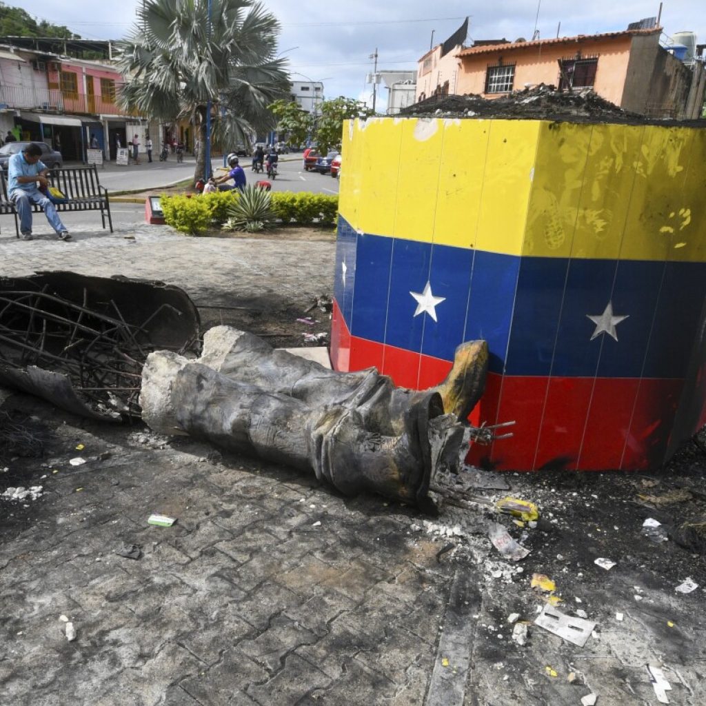 Hugo Chavez statues targeted across Venezuela in post-election unrest