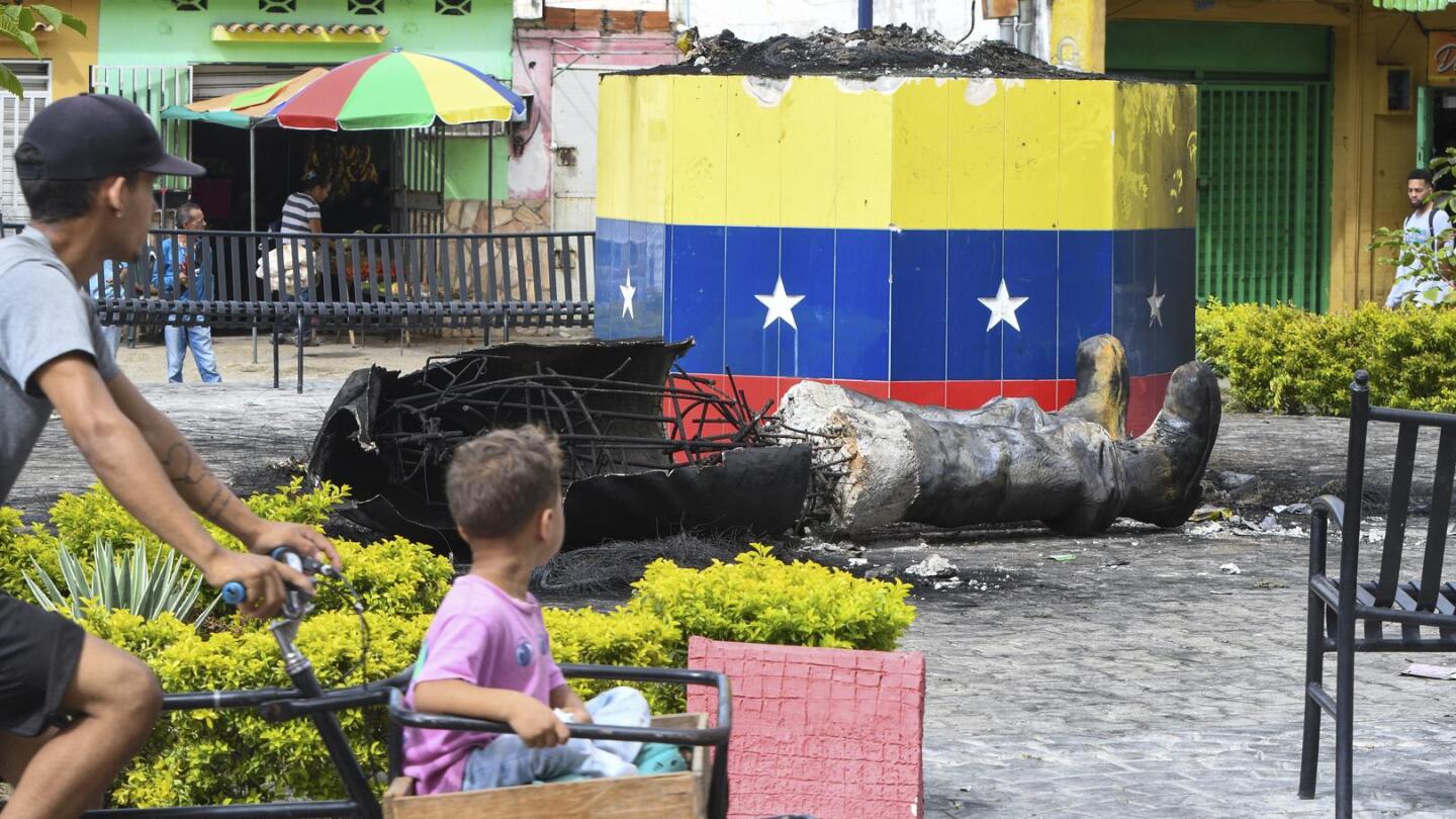 Protesters topple statues of Hugo Chavez in Venezuela as anger at election result grows | AP News