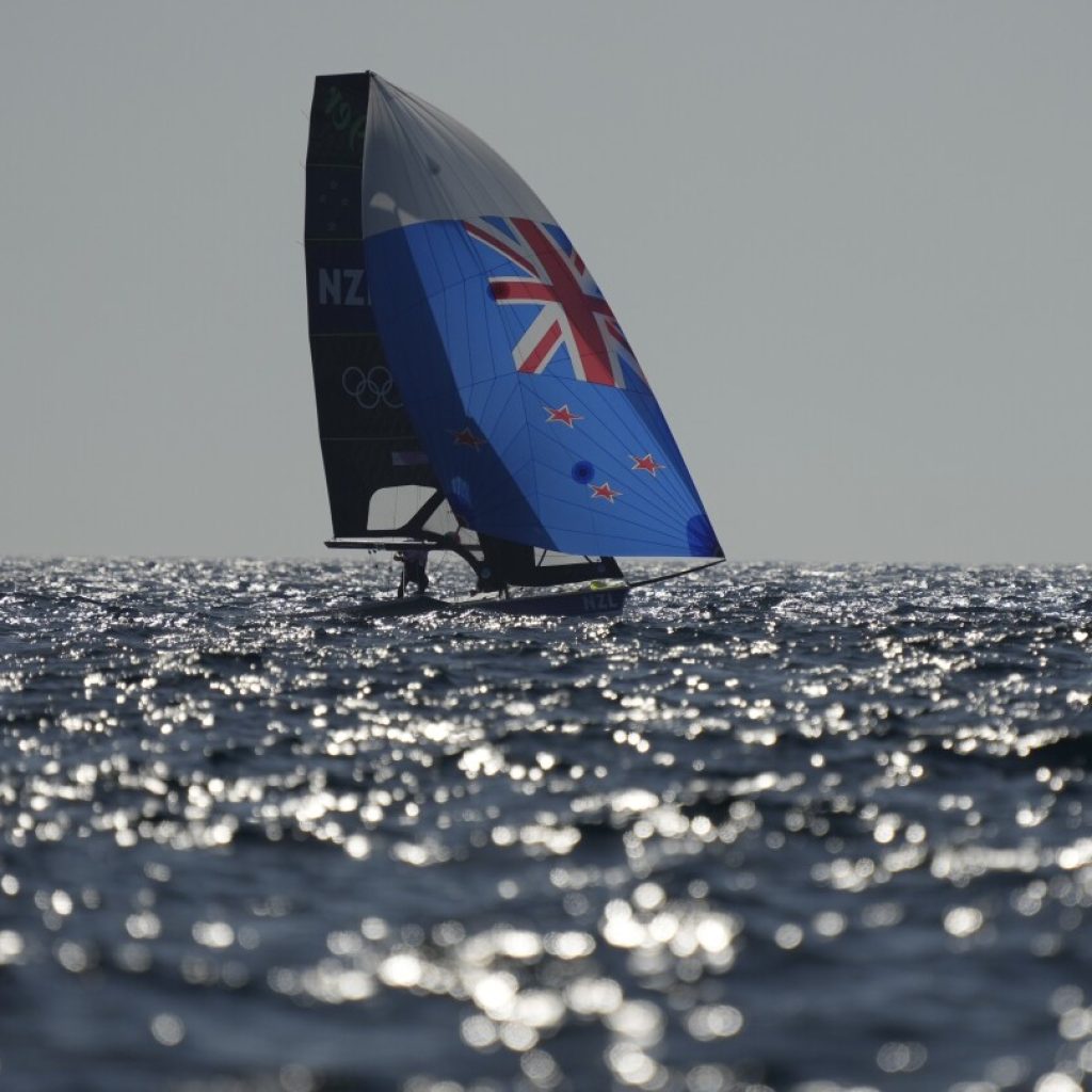 A lack of wind forces scuttles first Olympic sailing medal races, leaving sailors broiling