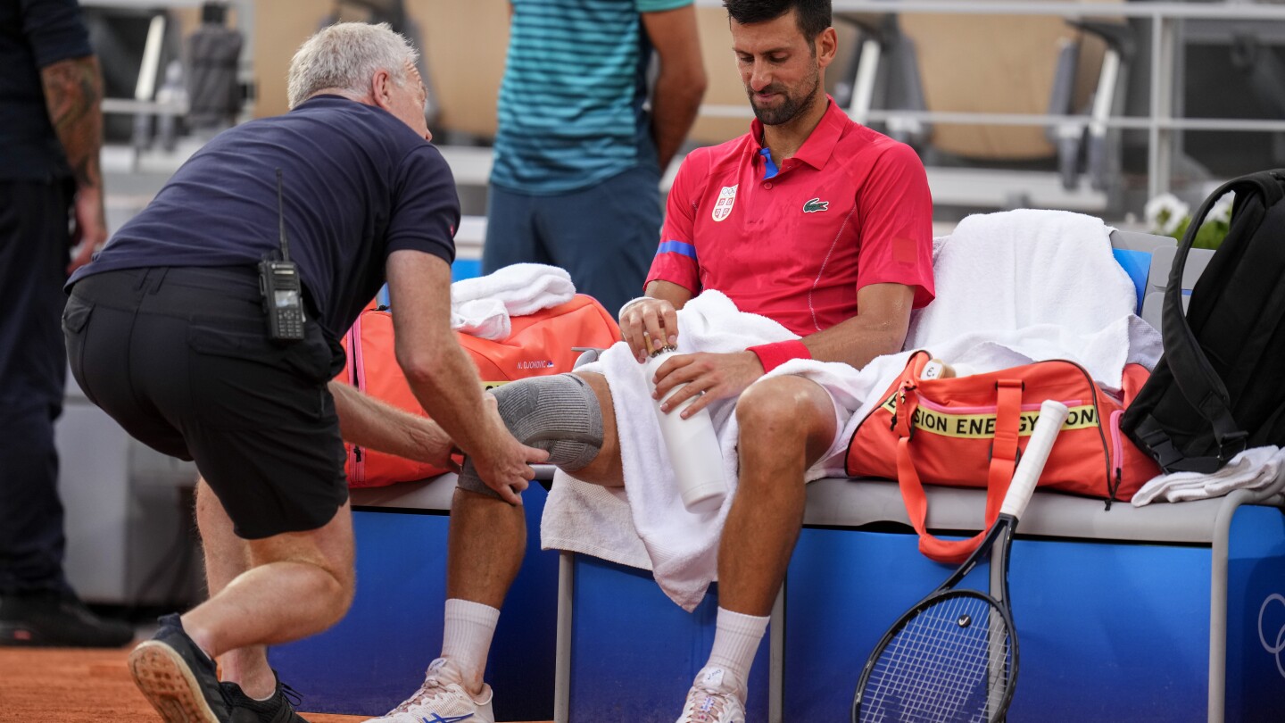 Novak Djokovic’s knee injury bothers him at the Paris Olympics but he beats Stefanos Tsitsipas