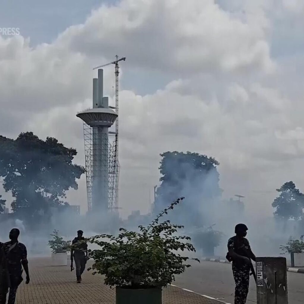 Security forces fire tear gas as anti-government protests break out across Nigeria | AP News