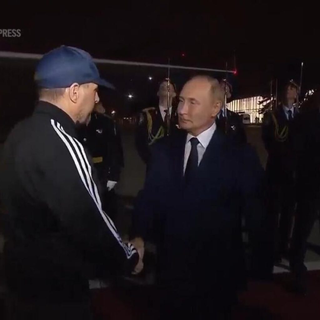 Putin greets prisoners freed in swap with US as they arrive in Moscow | AP News