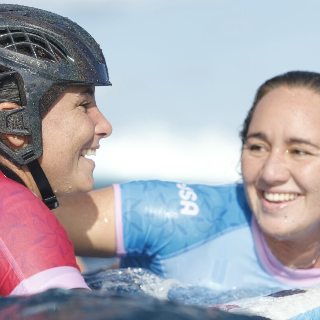 Defending women’s champion loses as Olympic surfing competition resumes with tricky Tahiti swells