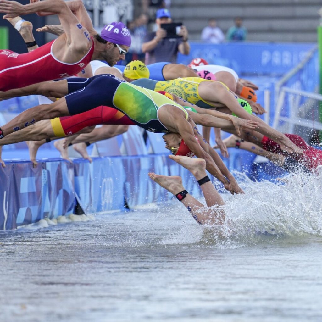 Olympic triathlon mixed relay gets underway with swims in the Seine amid water quality concerns