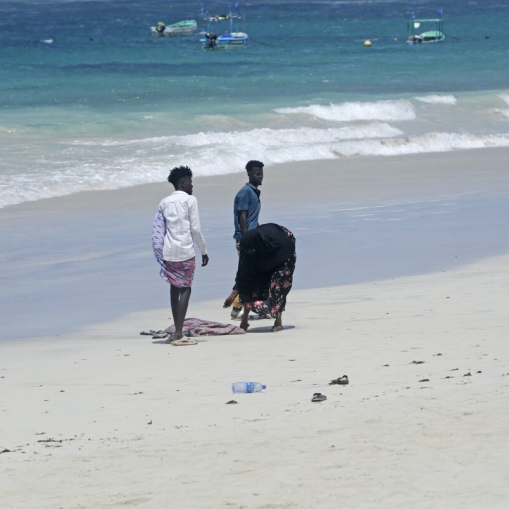 Hundreds gather at Somalia beach to condemn attack that killed 37 and demand stronger security