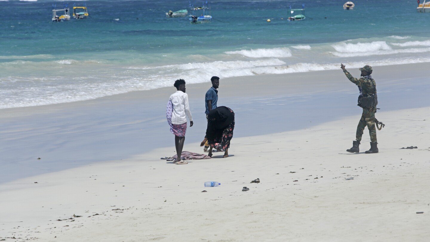 Hundreds gather at Somalia beach to condemn attack that killed 37 and demand stronger security