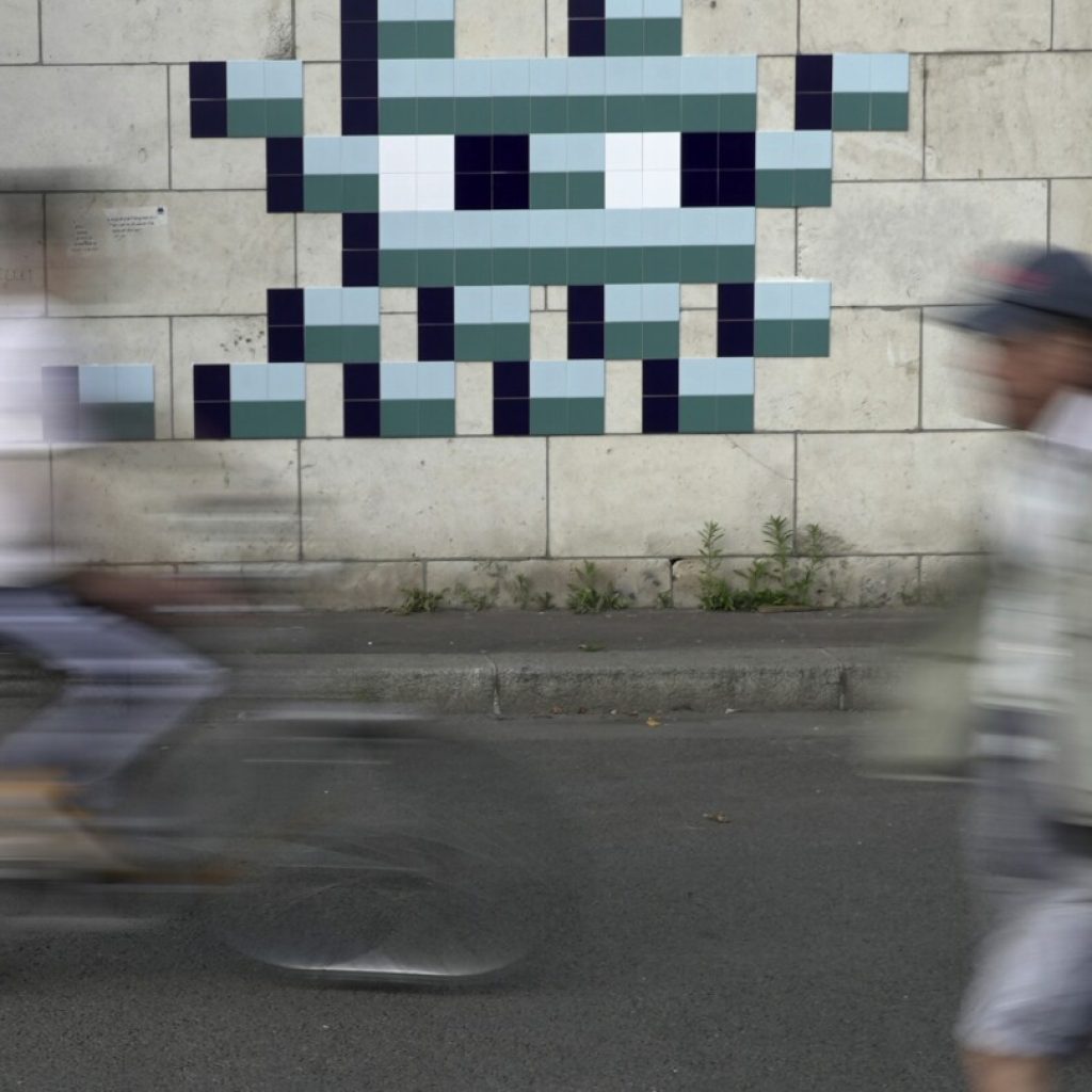 Mystery Paris street artist ‘Invader’ glues up new work to celebrate Olympics and delight fans