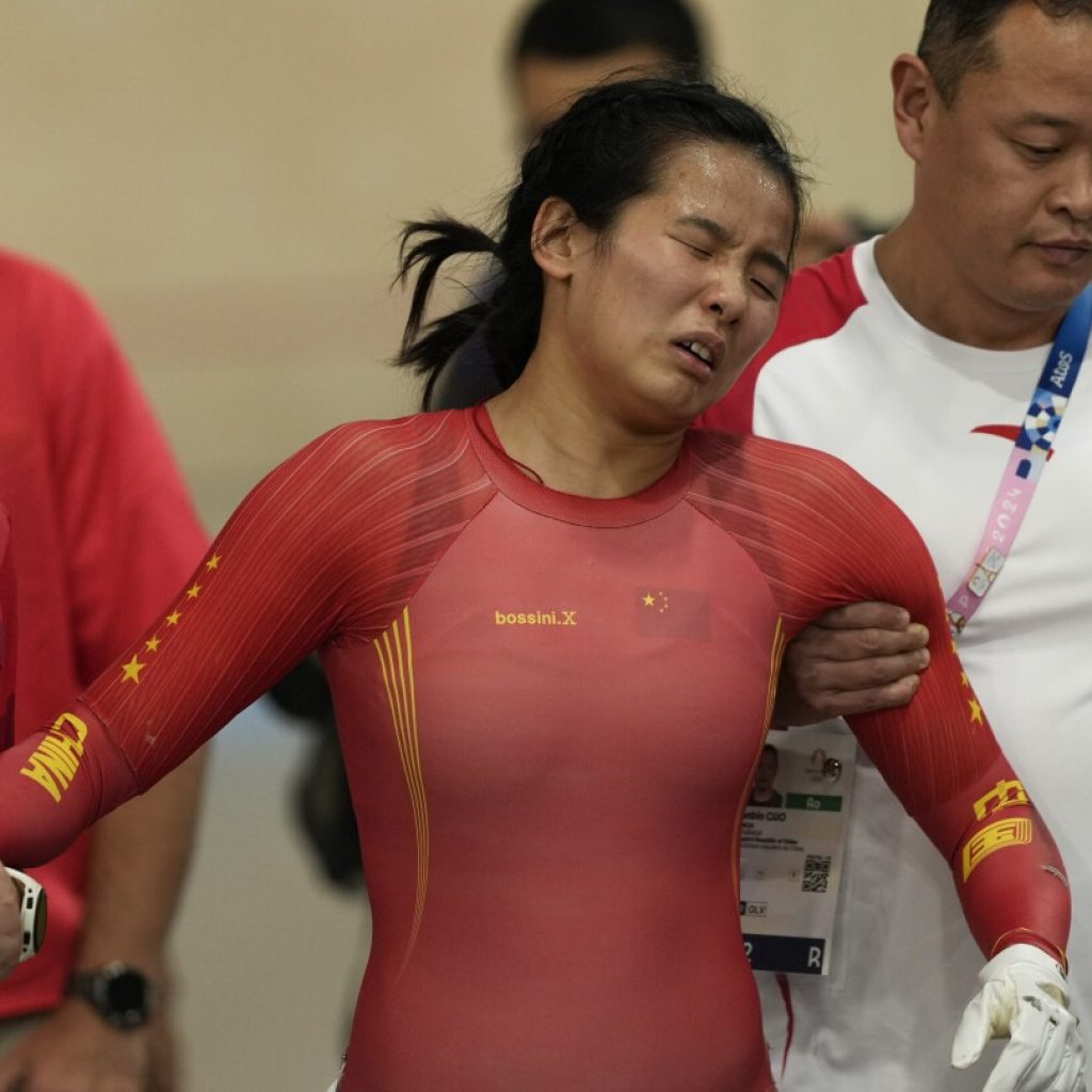 China track cyclist Yuan Liying has to be helped off velodrome after causing hard keirin crash