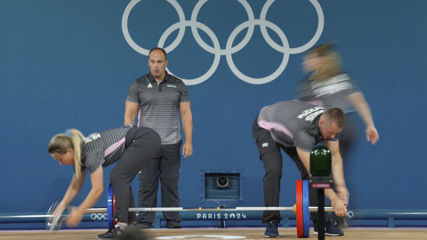 Like pit crews but in weightlifting. How loaders keep the Olympic sport going