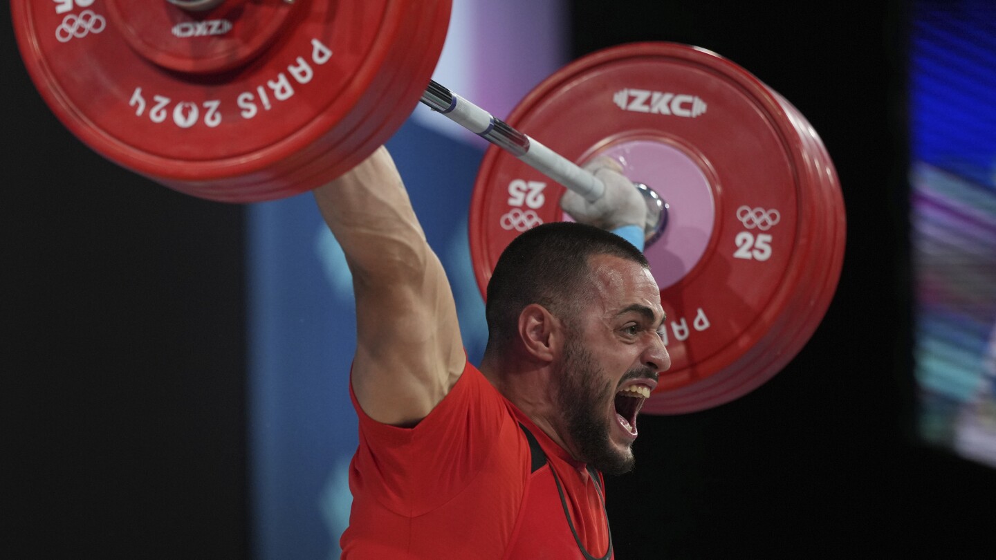 Bulgaria weightlifter wins gold 15 months since a hotel sink fell and severed an Achilles tendon