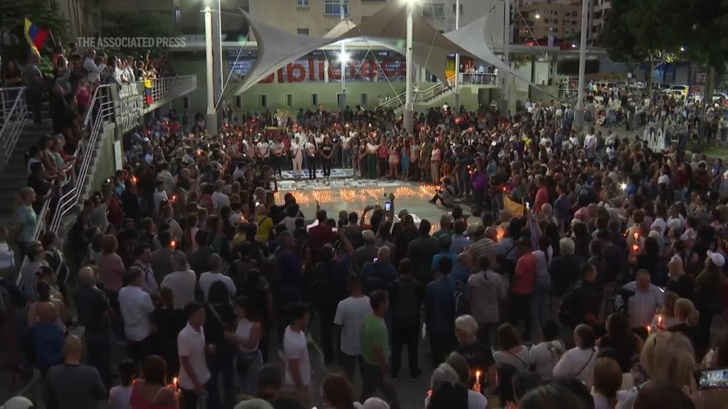 Demonstrators hold vigil for detained protesters in Venezuela capital and pray for peace and freedom | AP News