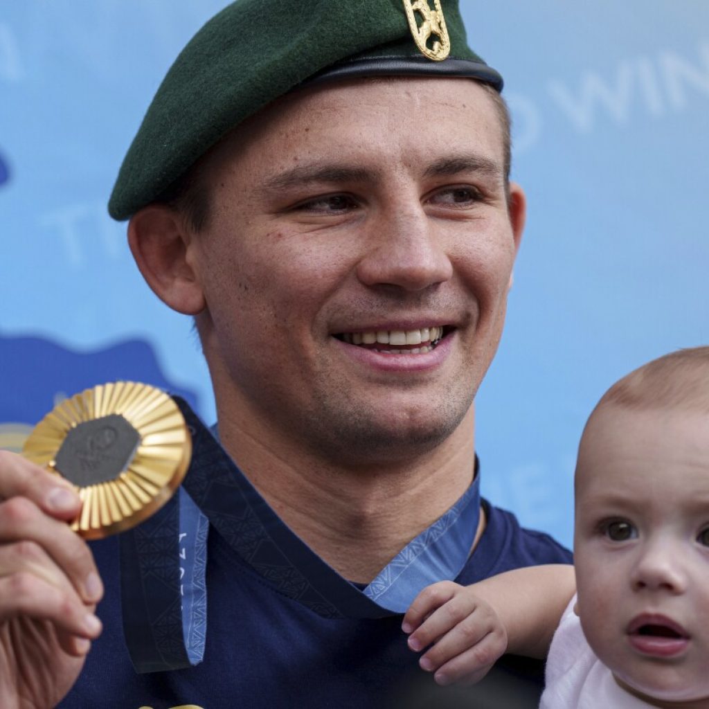 Oleksandr Khyzhniak, Ukraine’s gold medal-winning boxer, returns home and lifts spirits amid war