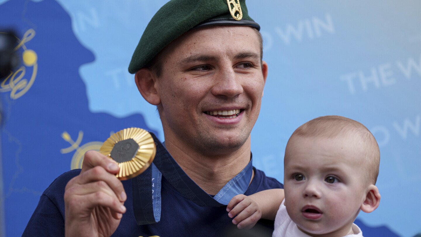 Oleksandr Khyzhniak, Ukraine’s gold medal-winning boxer, returns home and lifts spirits amid war