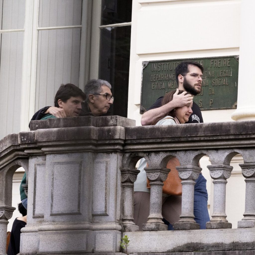 Families of Brazilian plane crash victims gather in Sao Paulo as experts work to identify the dead