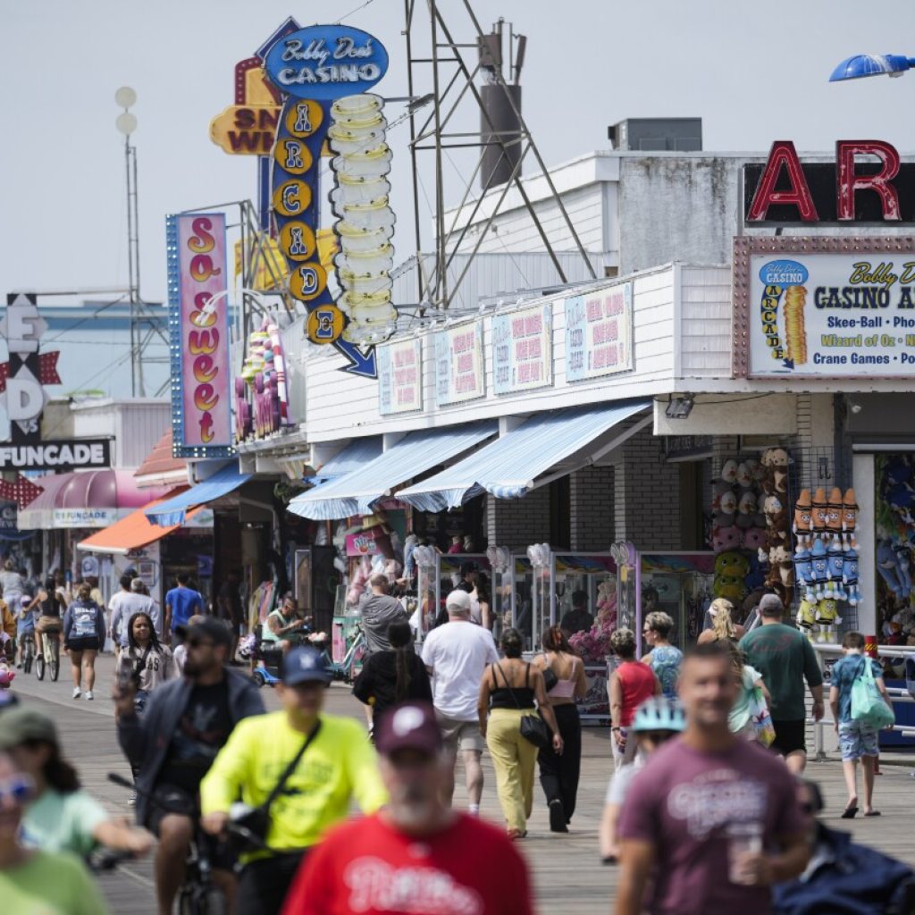 Summer tourists flock to boardwalks and piers while sticking to their budgets