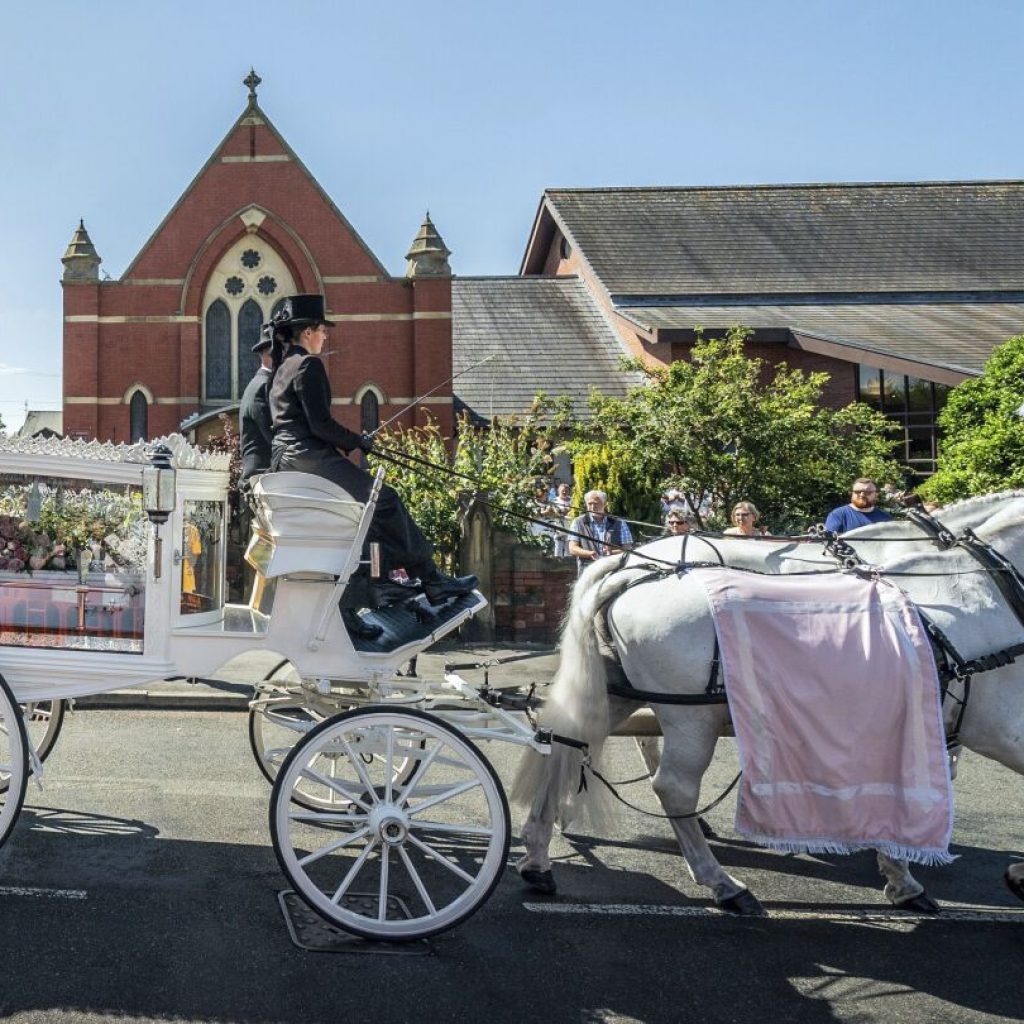 English town of Southport mourns 9-year-old stabbing victim and calls for an end to unrest