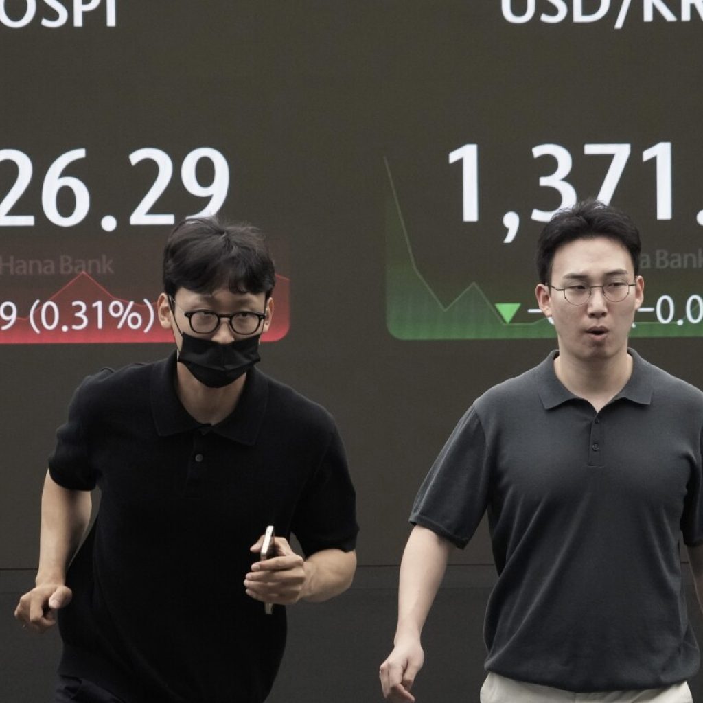 Asian shares trade mixed as Japan and other markets calm from a previous week of crazy swings