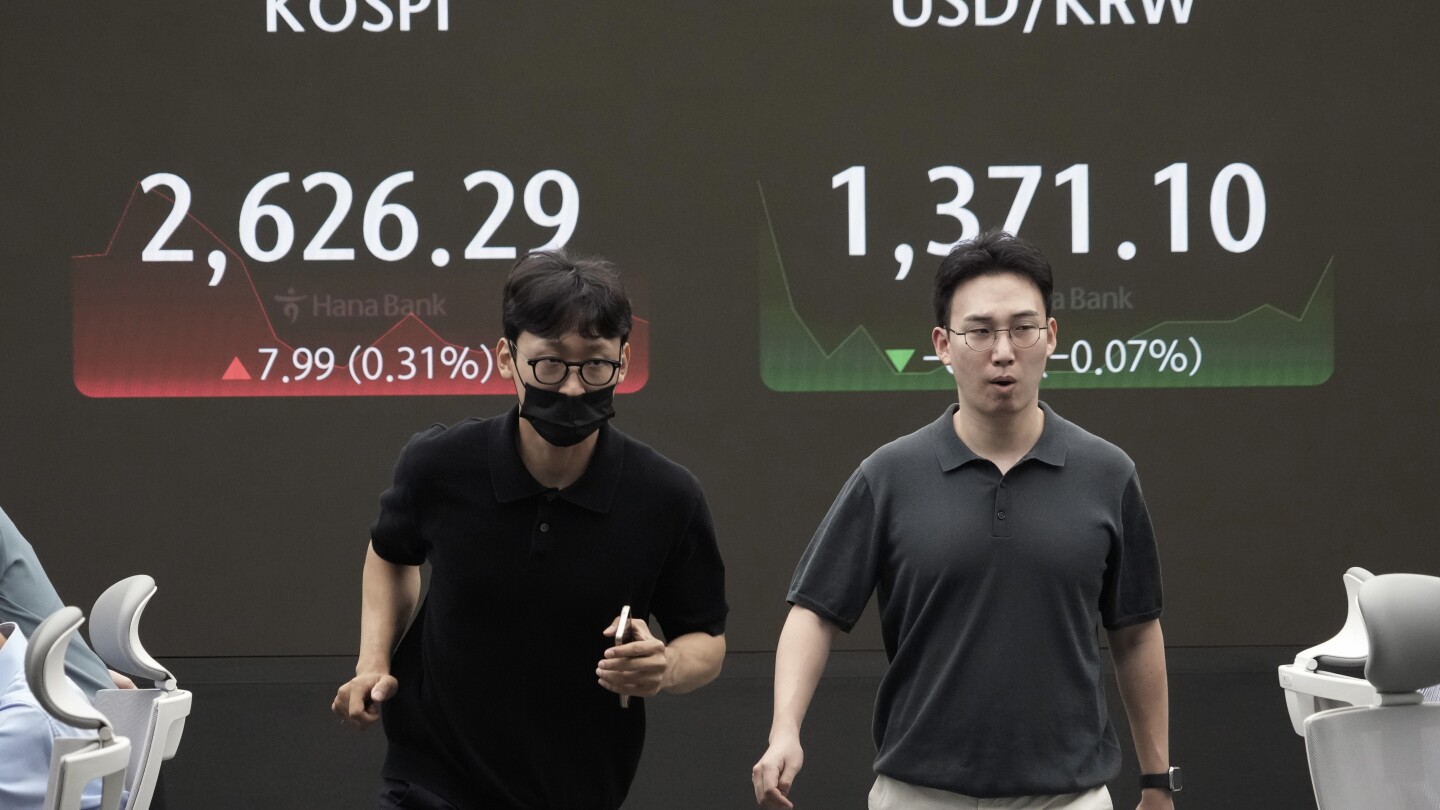 Asian shares trade mixed as Japan and other markets calm from a previous week of crazy swings