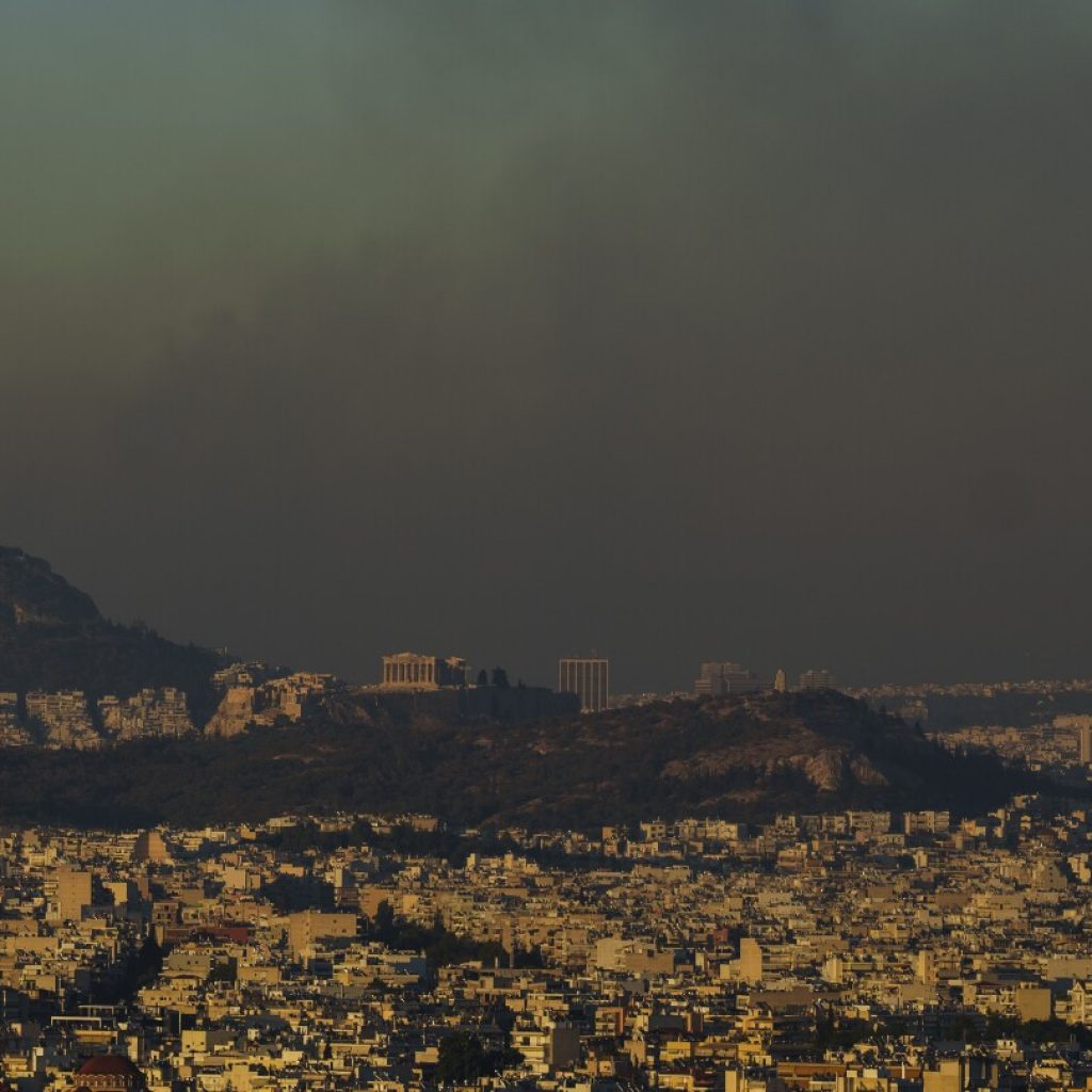 Crews battle scattered fires in Athens suburbs, helped by calmer winds and reinforcements