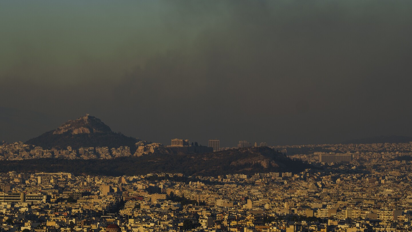 Crews battle scattered fires in Athens suburbs, helped by calmer winds and reinforcements