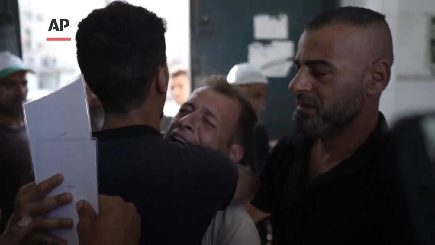 Palestinian father mourns wife and days old twins killed in Israeli bombardment of central Gaza | AP News