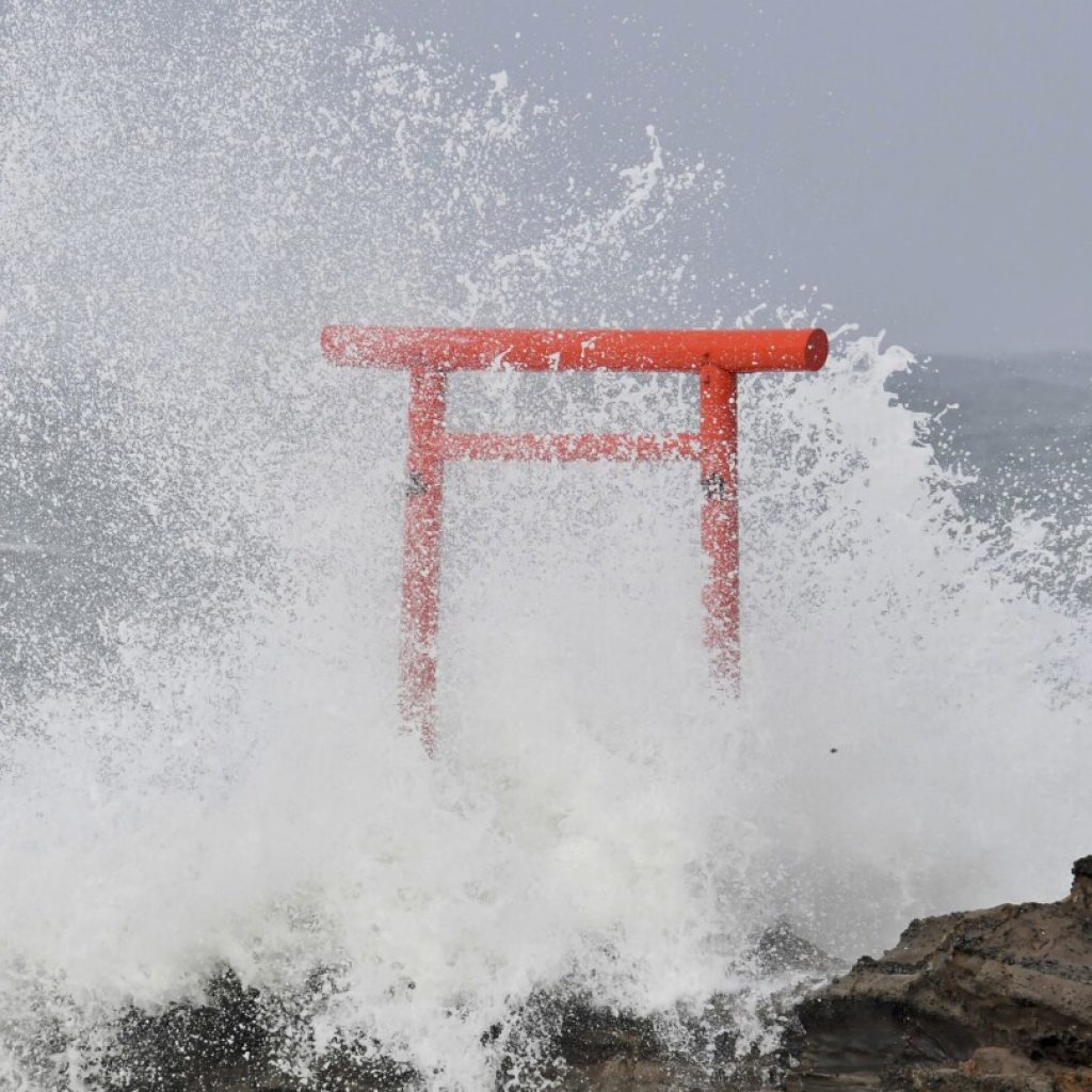 Typhoon Ampil moves away from Japan as train services resume and no major damage is reported