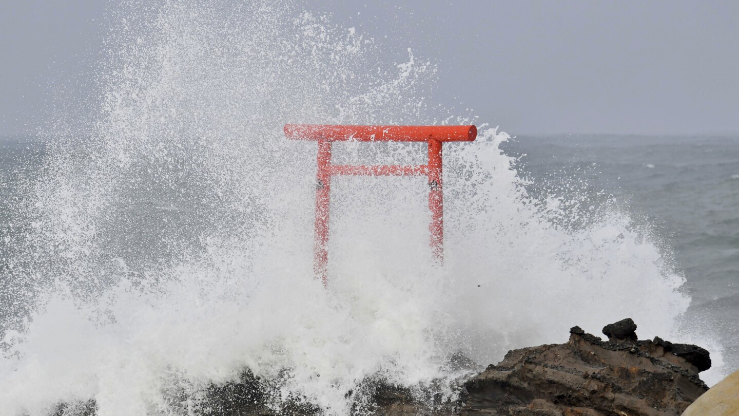 Typhoon Ampil moves away from Japan as train services resume and no major damage is reported