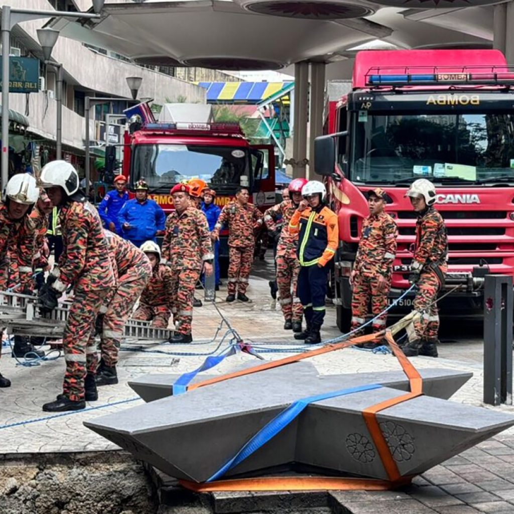 Woman plunges into 8-meter deep hole after pavement sinks in Malaysia