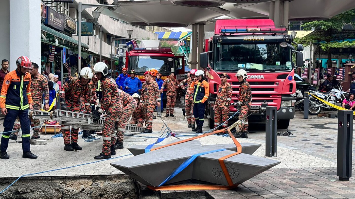 Woman plunges into 8-meter deep hole after pavement sinks in Malaysia