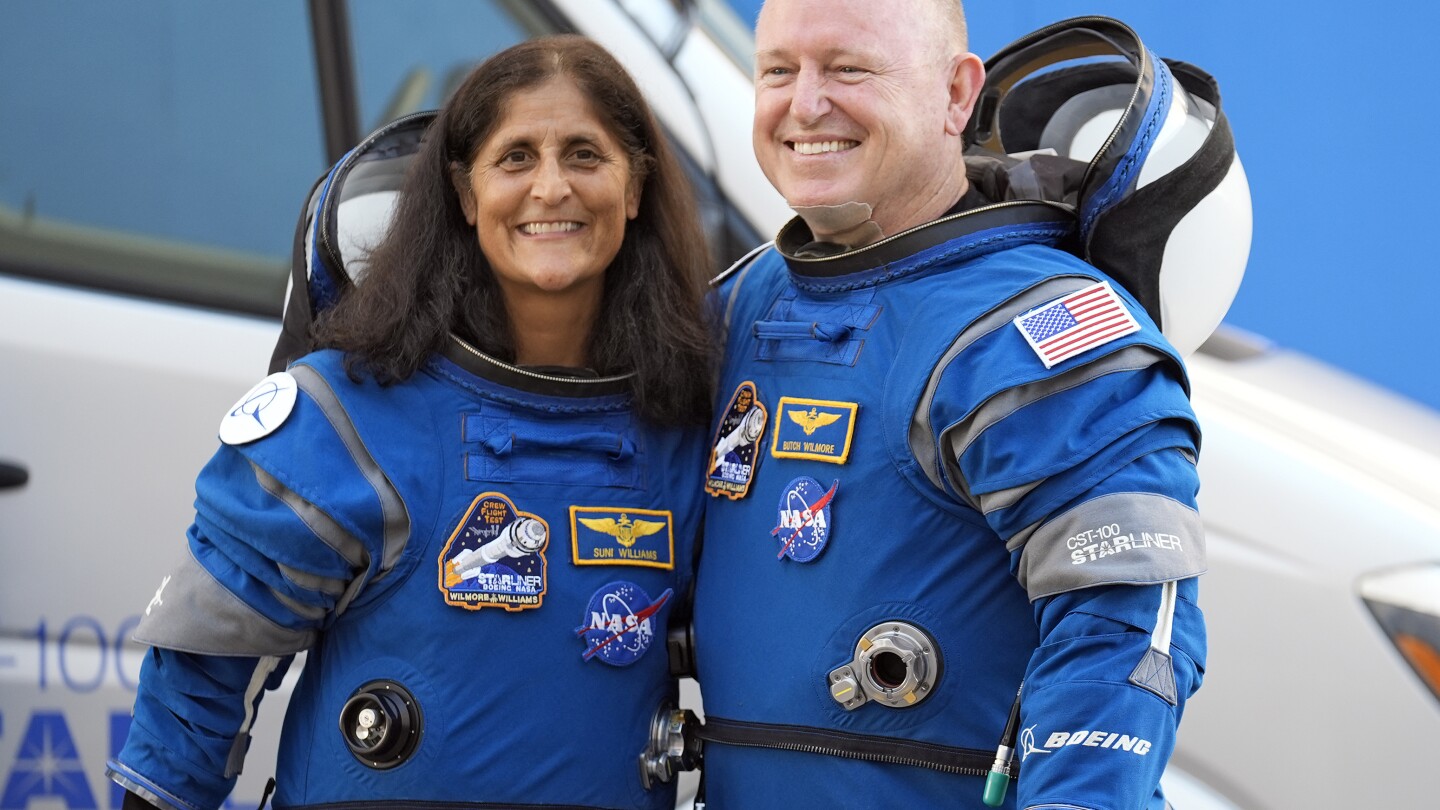 NASA astronauts who will spend extra months at the space station are veteran Navy pilots