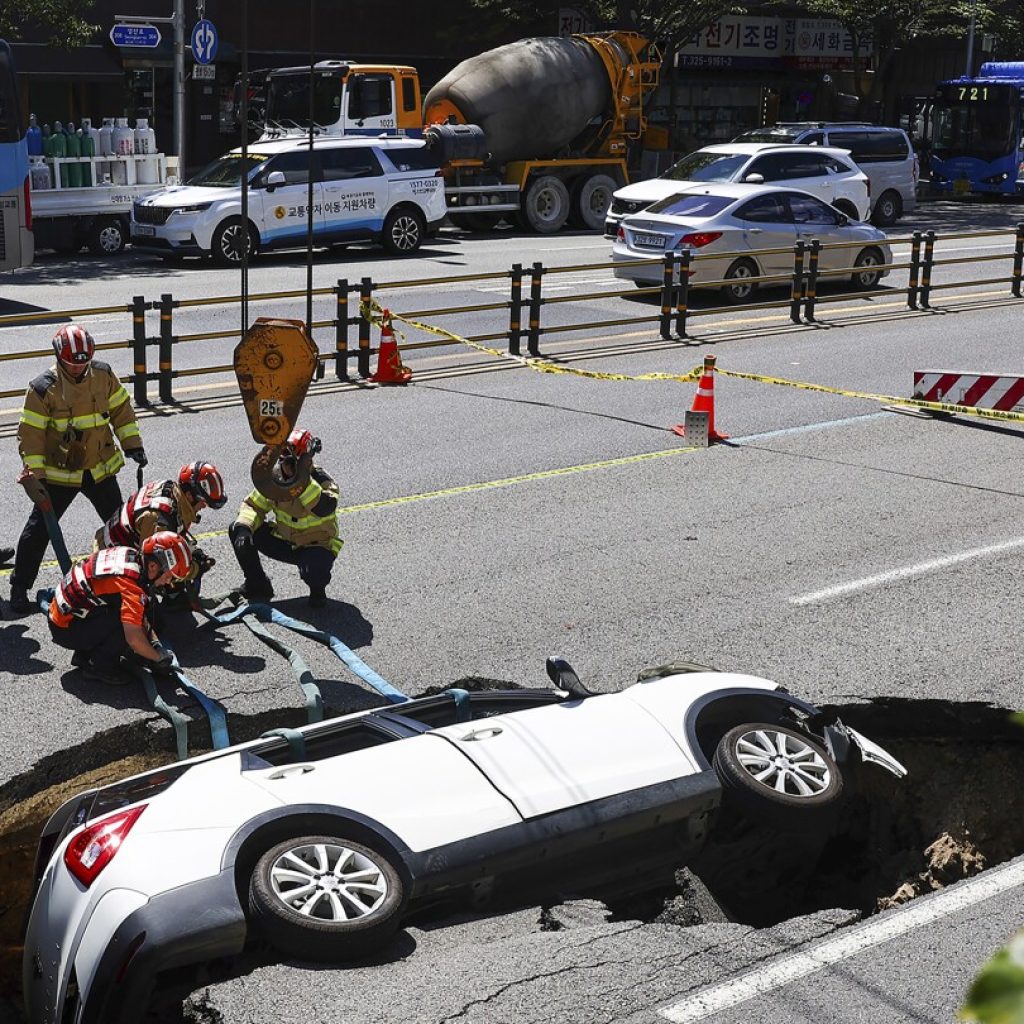 A sinkhole swallows an SUV in South Korea, injuring 2 people