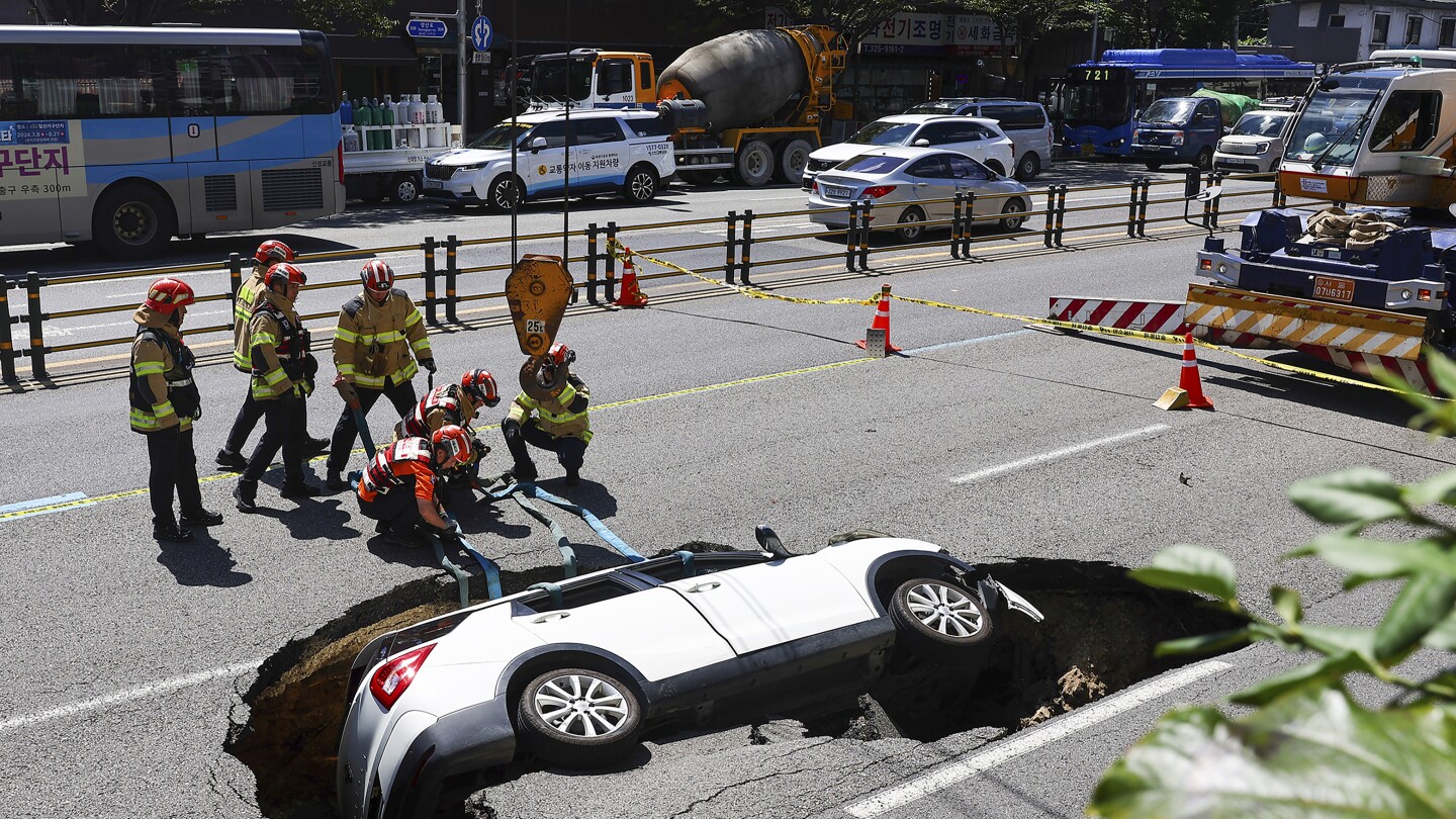 A sinkhole swallows an SUV in South Korea, injuring 2 people