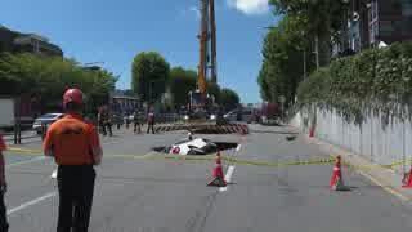 Sinkhole swallows a car in South Korea, injuring two people | AP News