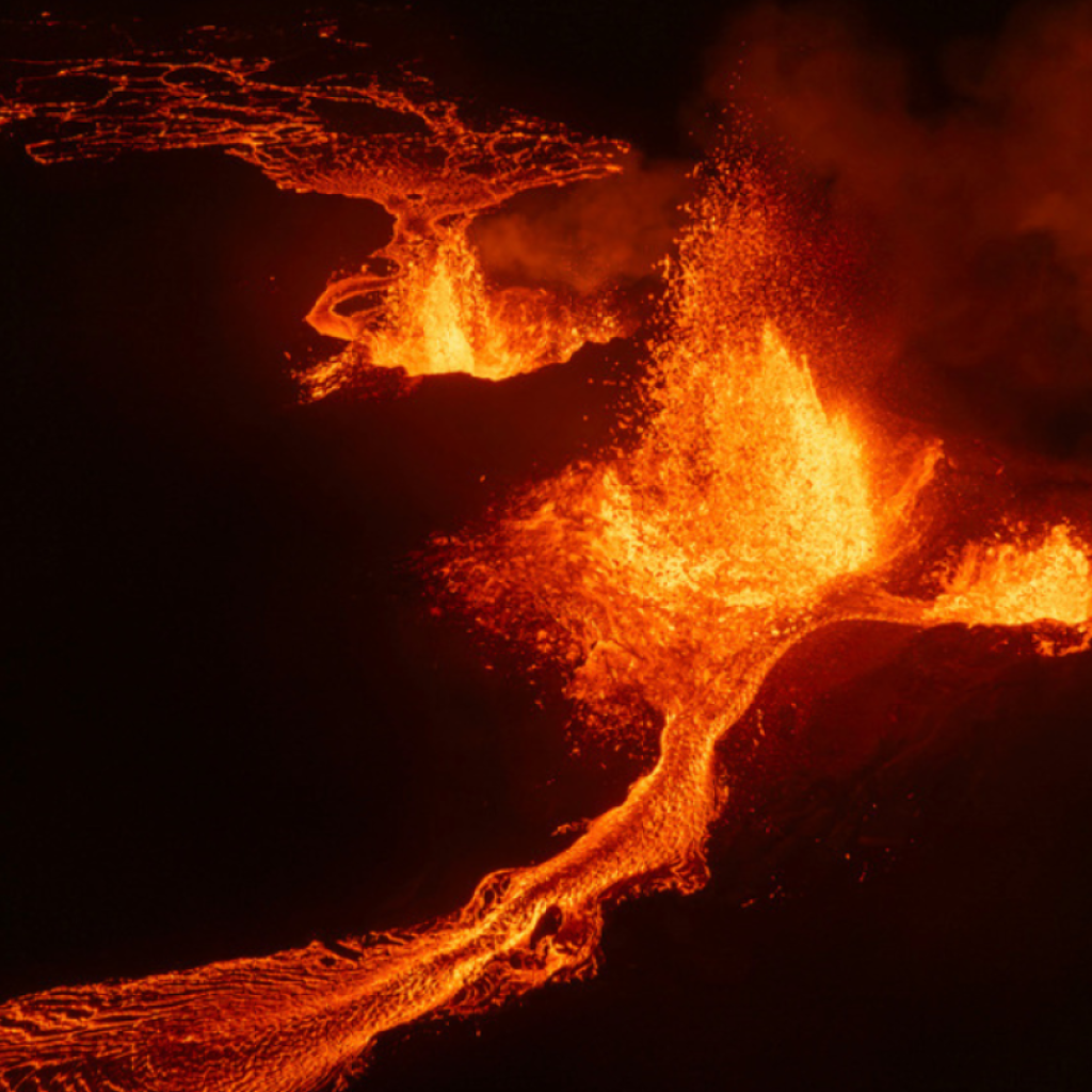 Northern lights shine in night sky as lava spews from erupting volcano in Iceland | AP News