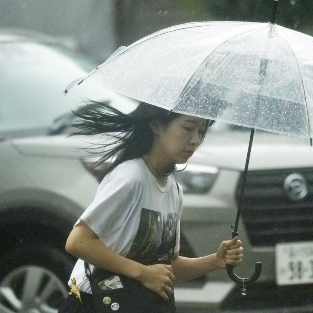 Storm slowly heads toward Japan’s capital, leaving mudslides and broken bridges in its path