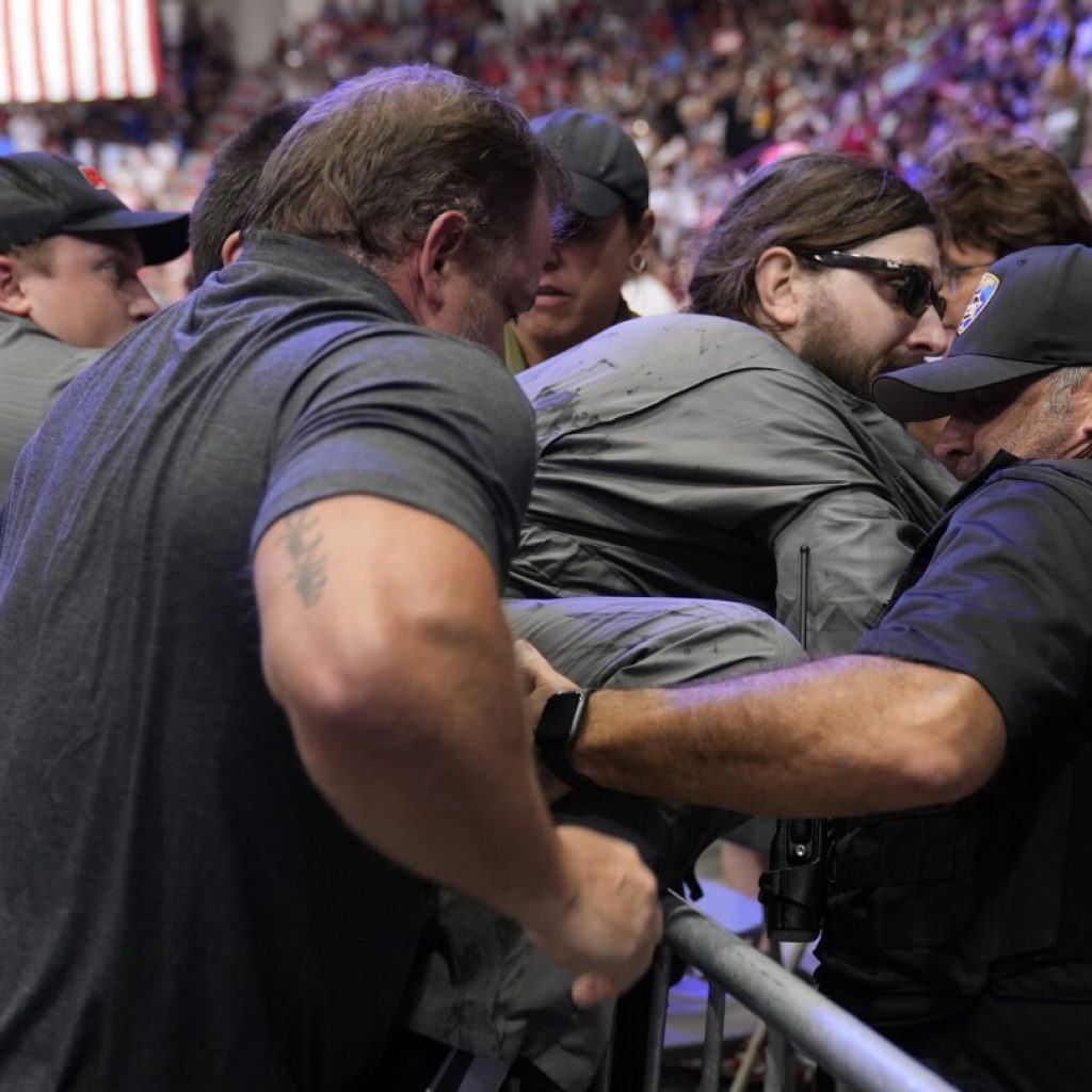 Police say a man will face charges after storming into the press area at a Trump rally