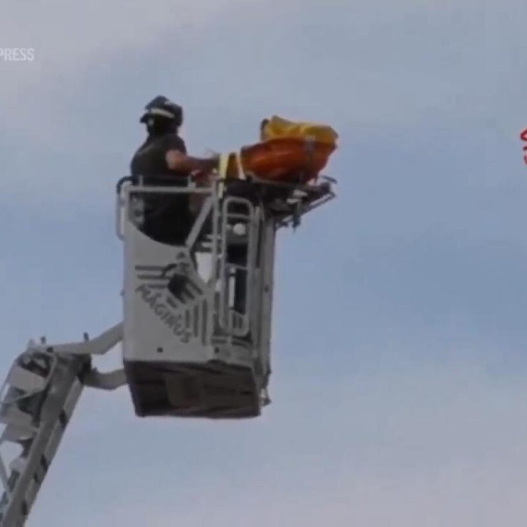 Watch the moment firefighters rescue a tourist from the leaning tower of Pisa | AP News