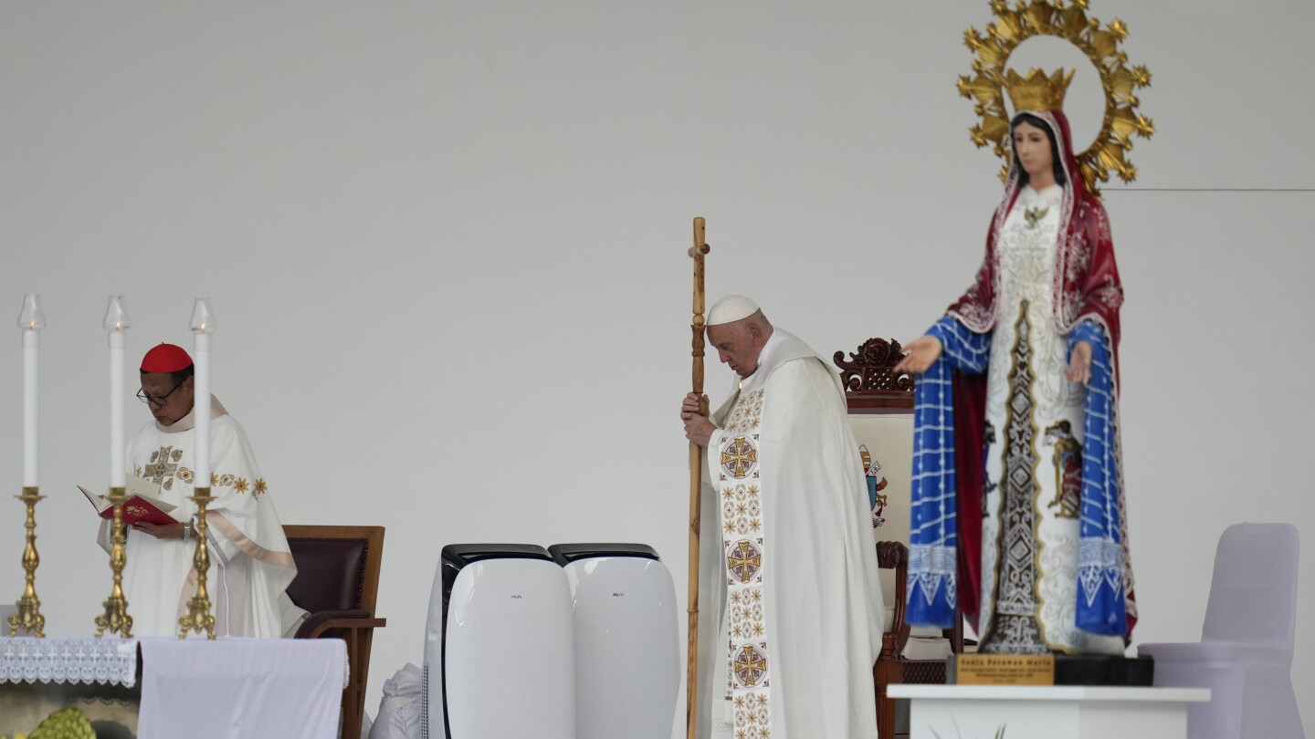 Pope heads to Papua New Guinea after final Mass in Indonesia before an overflow crowd of 100,000