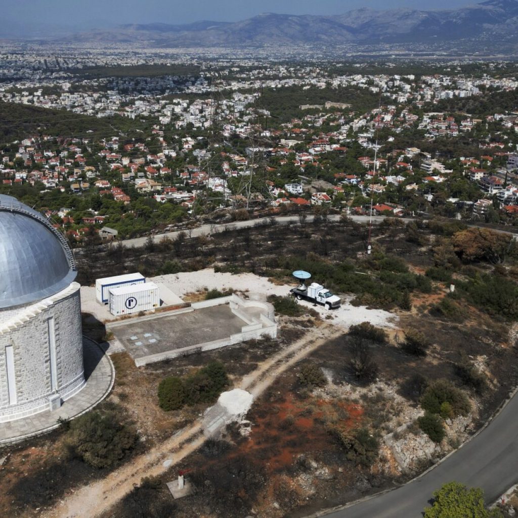 AP PHOTOS: A ferocious blaze scars the land outside Greece’s capital